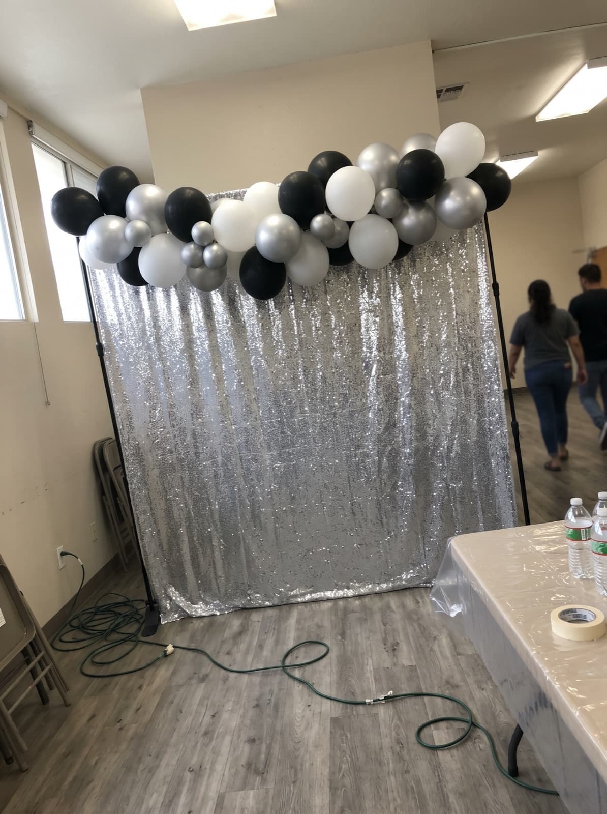 Silver sequin wall topped with a black and white garland