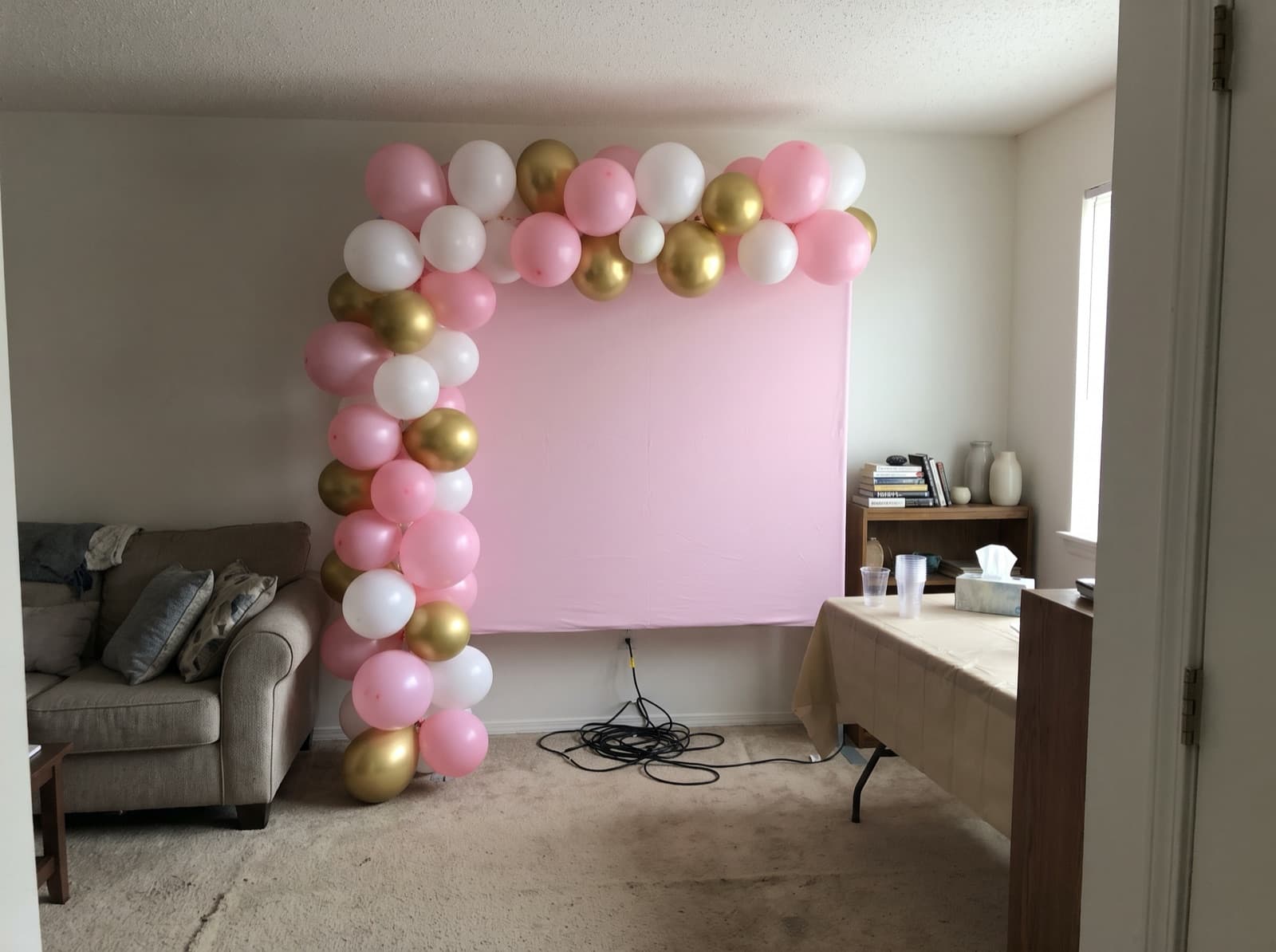 Pale pink square panel with a garland climbing one side