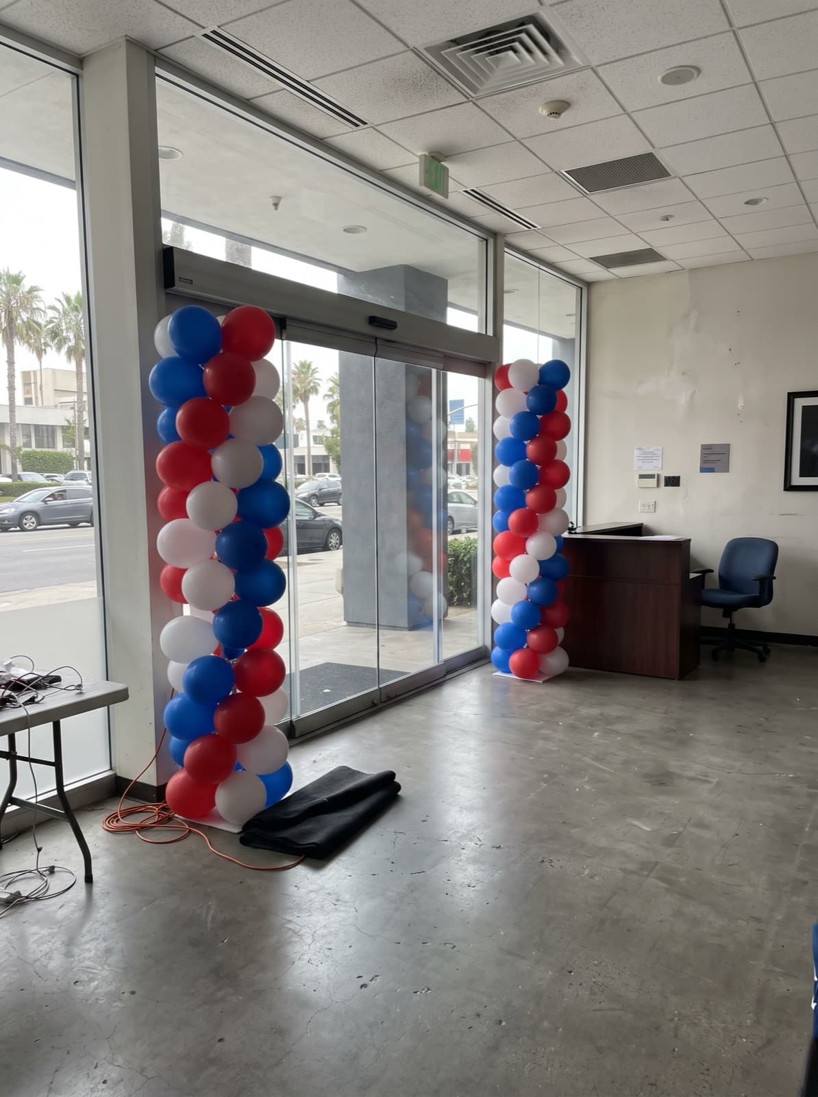 Red, white and blue spiral columns at an office lobby door