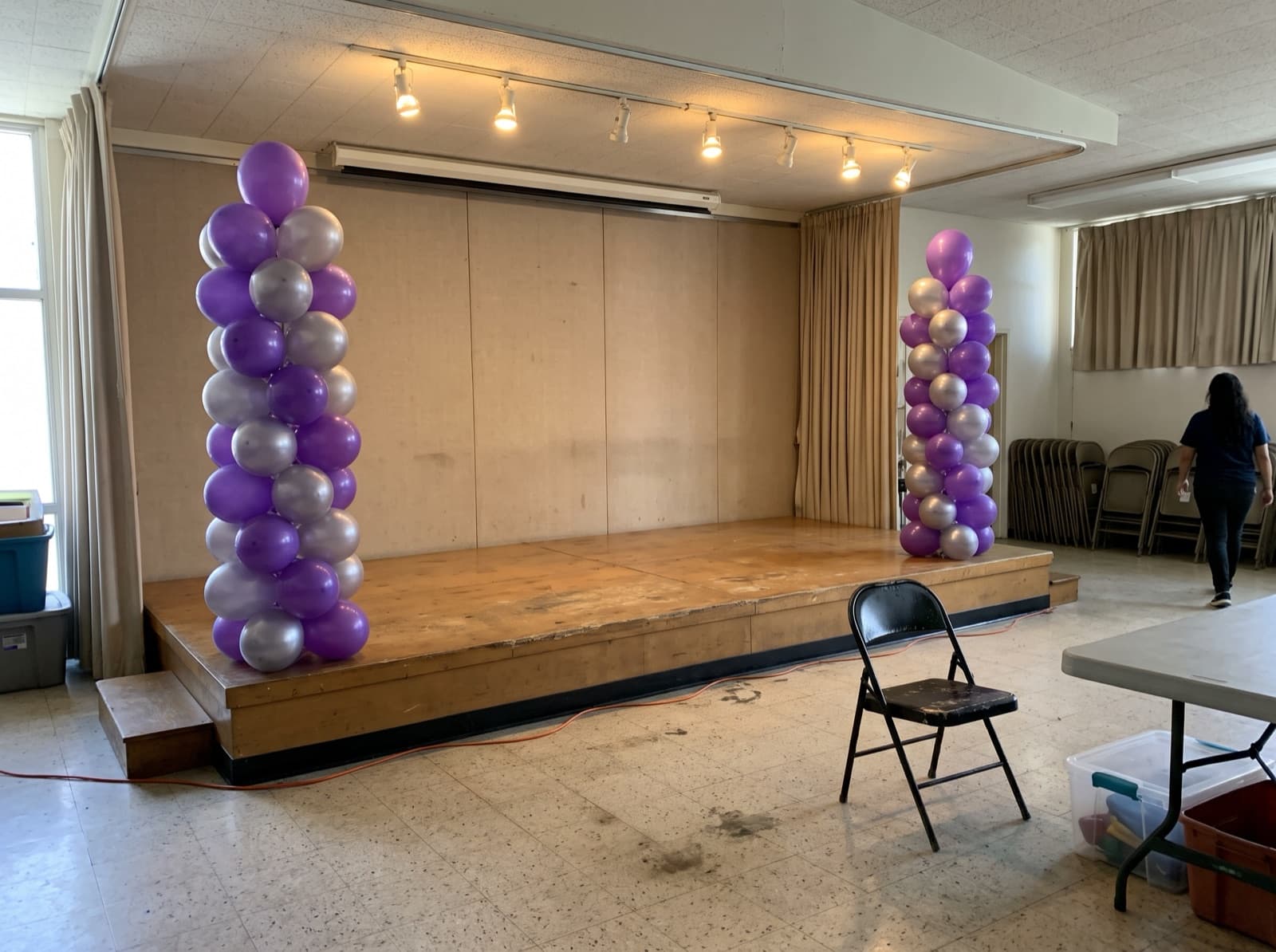 Purple and silver columns bookending a school stage