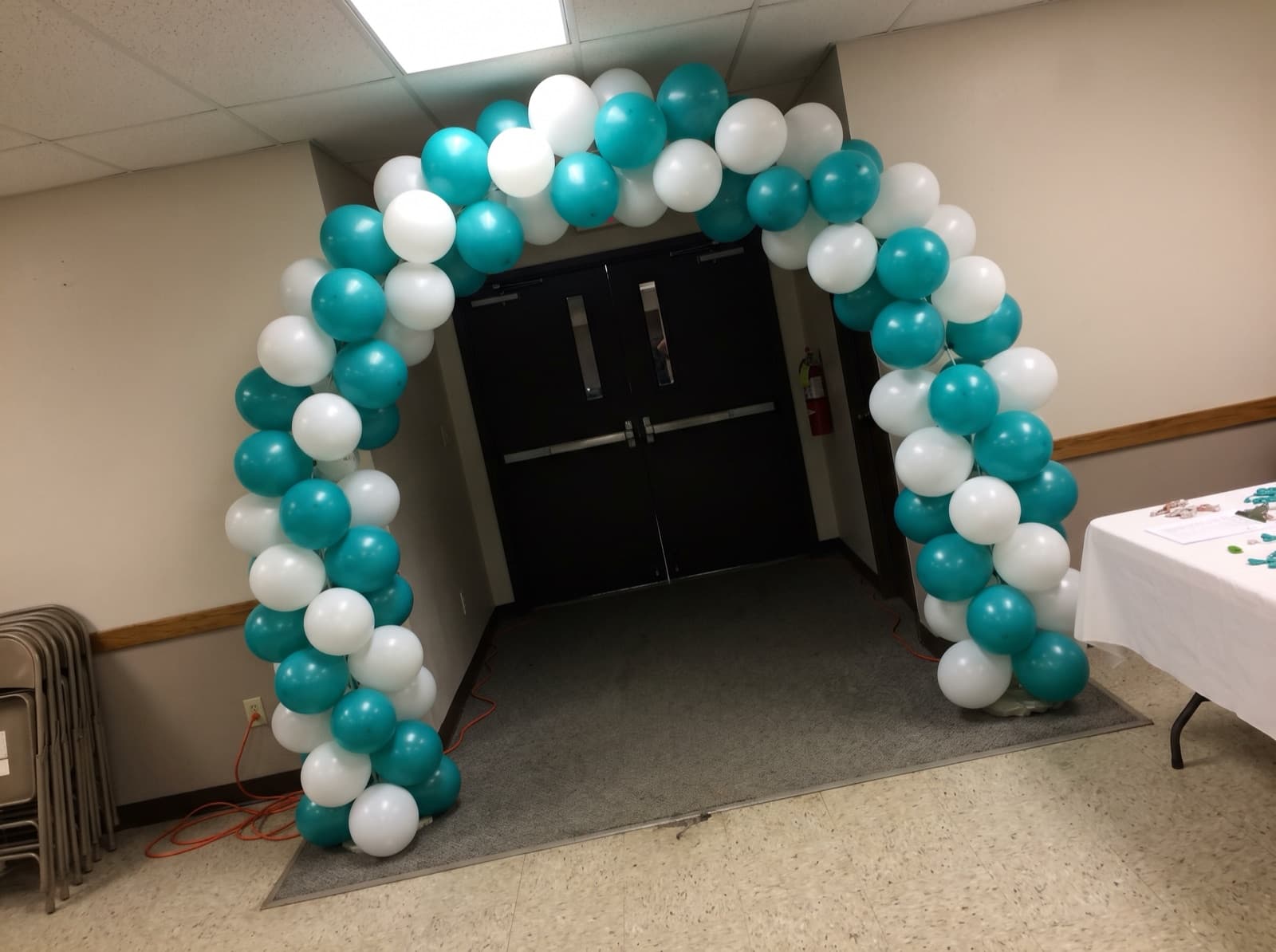 Teal and white columns linked by a classic arch