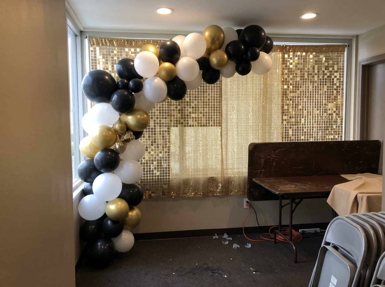 Black, white and gold garland on a gold sequin wall