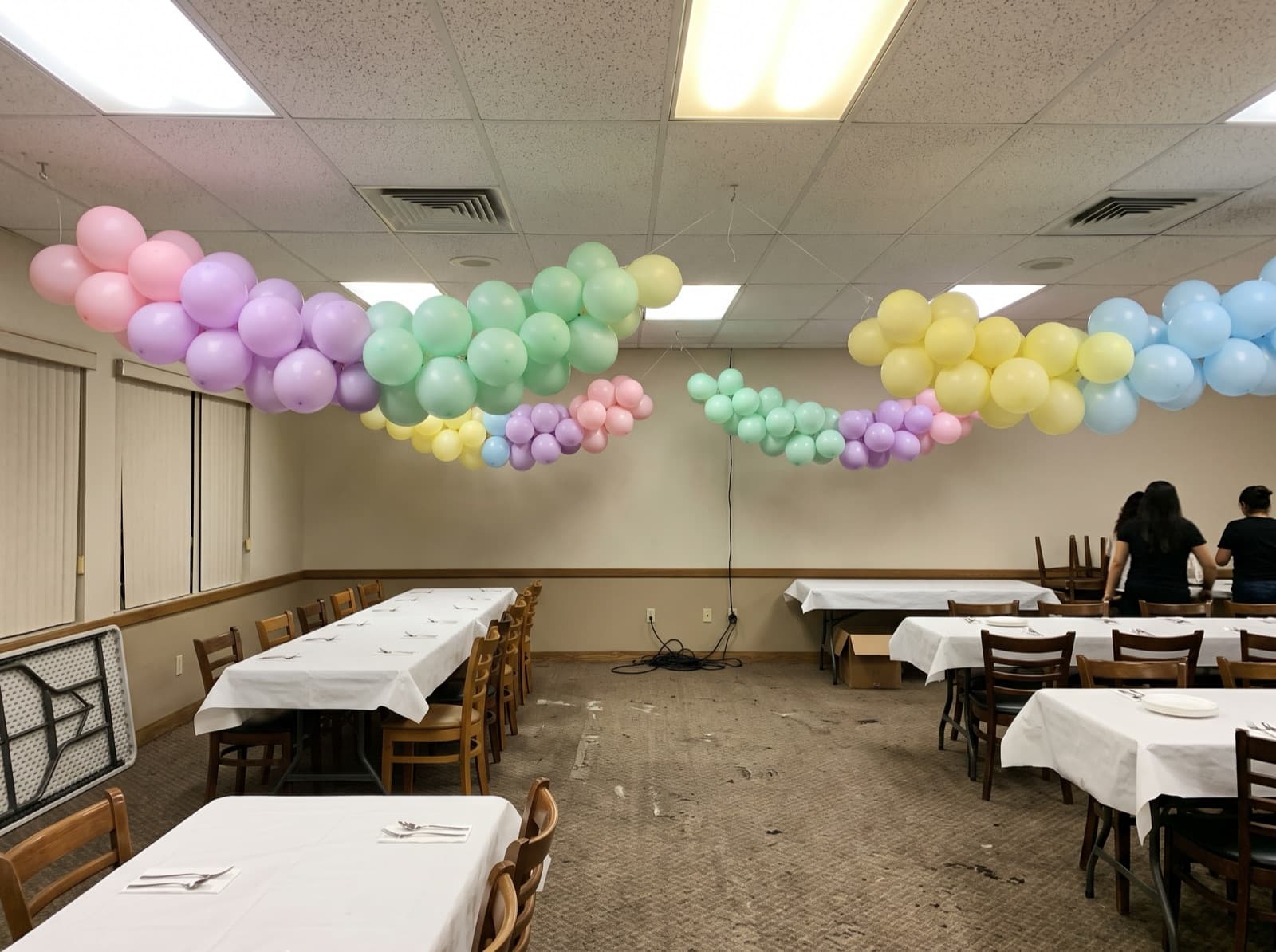 Pastel garland swags hung over long dining tables