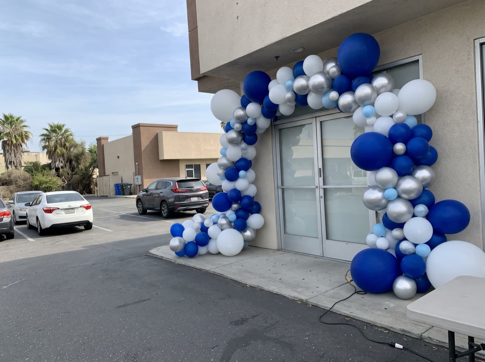 Oversized blue, white and silver arch over a store entry