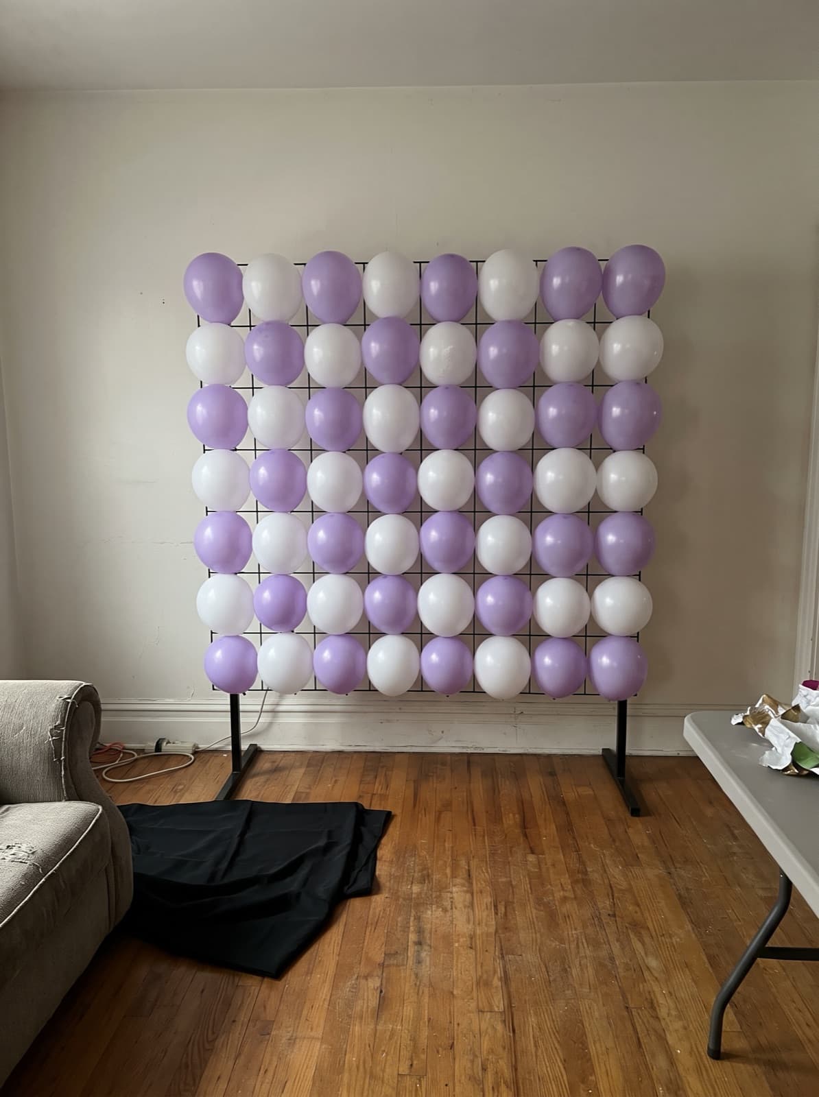 Lavender and white checkerboard grid wall in a living room